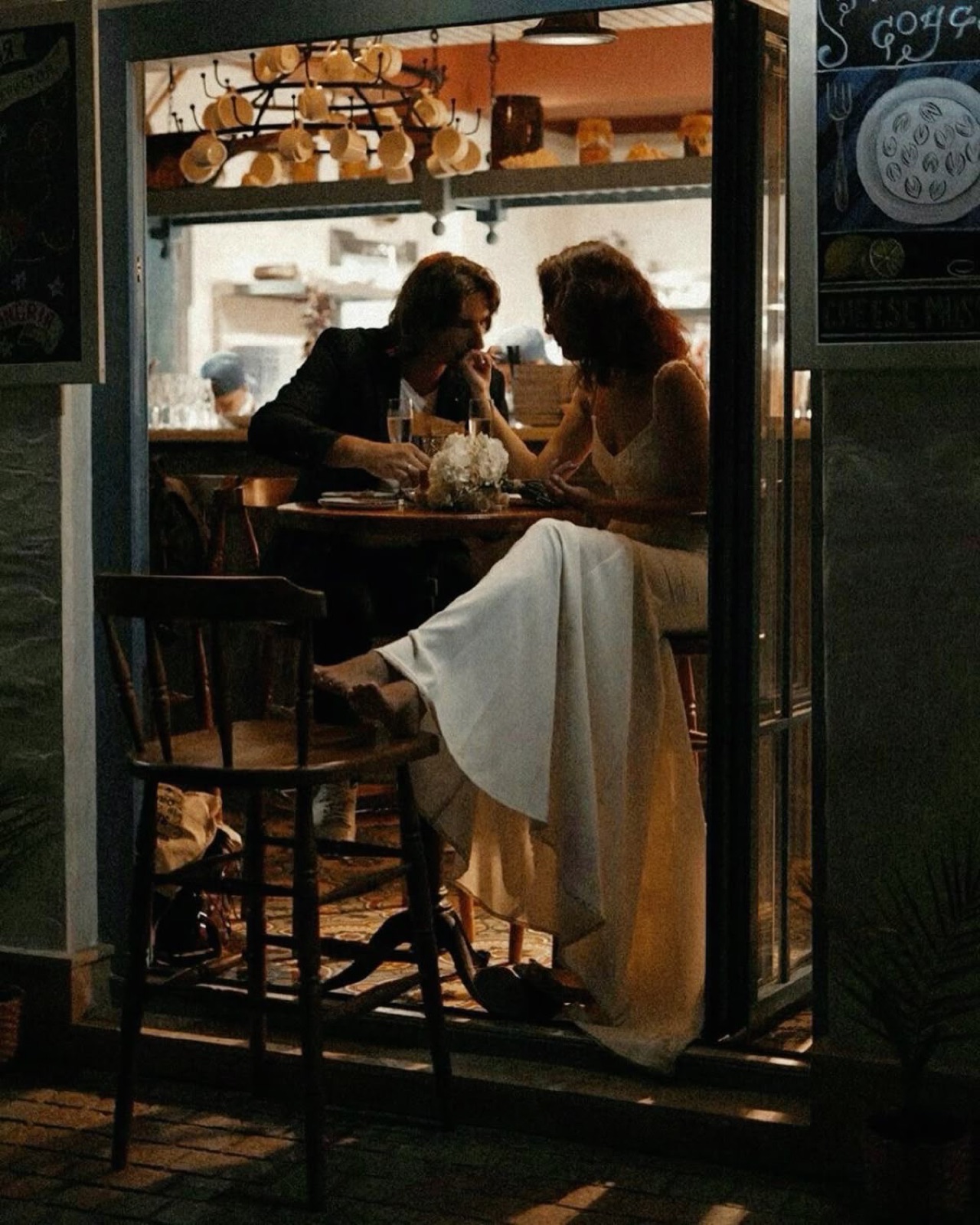 Couple having dinner in a warmly lit café at night