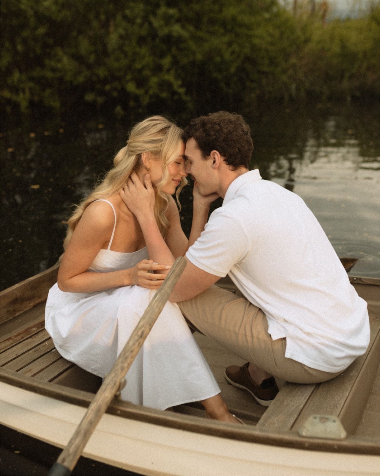 Couple in a rowboat on a quiet lake