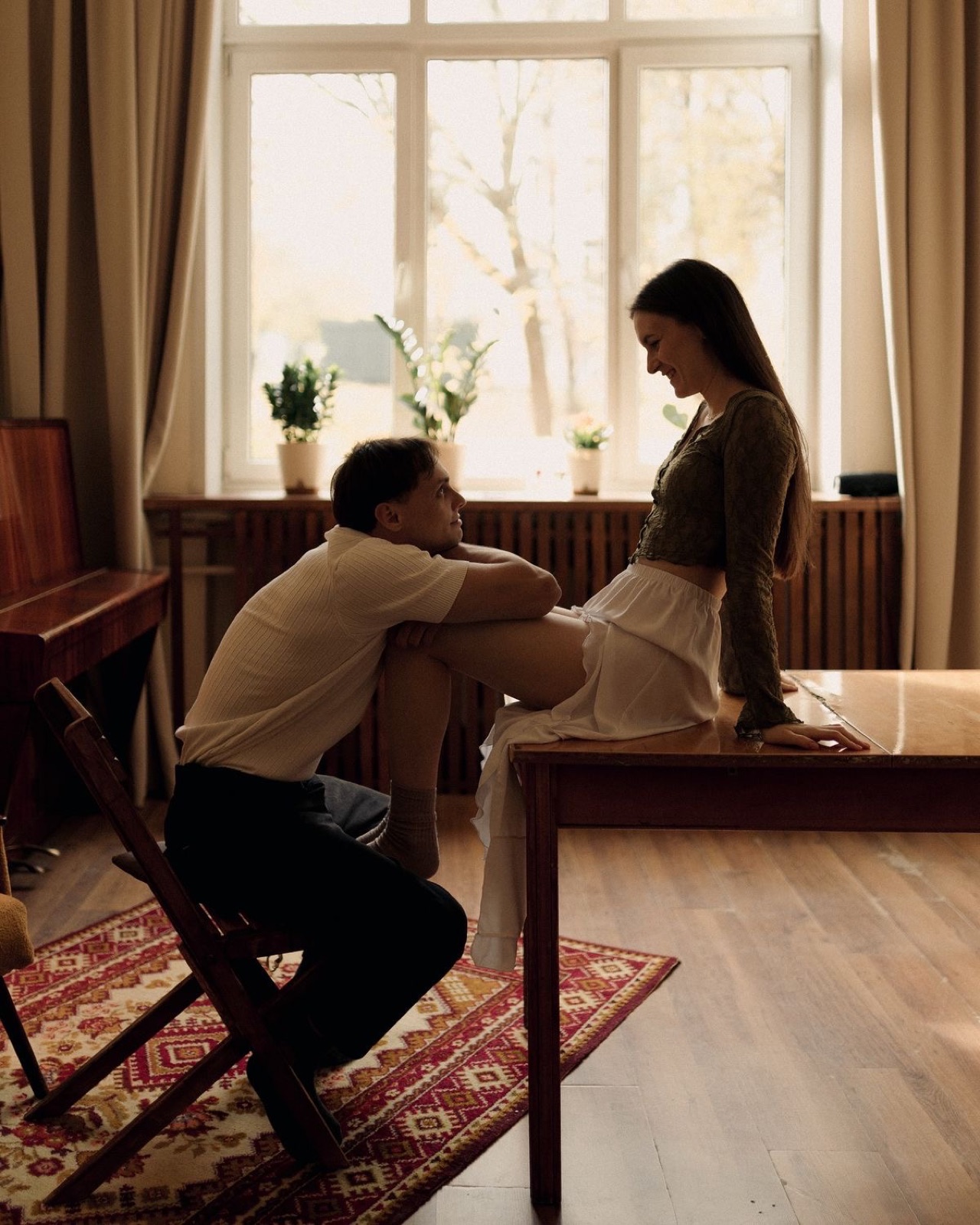 Couple sharing a quiet moment at home by the window