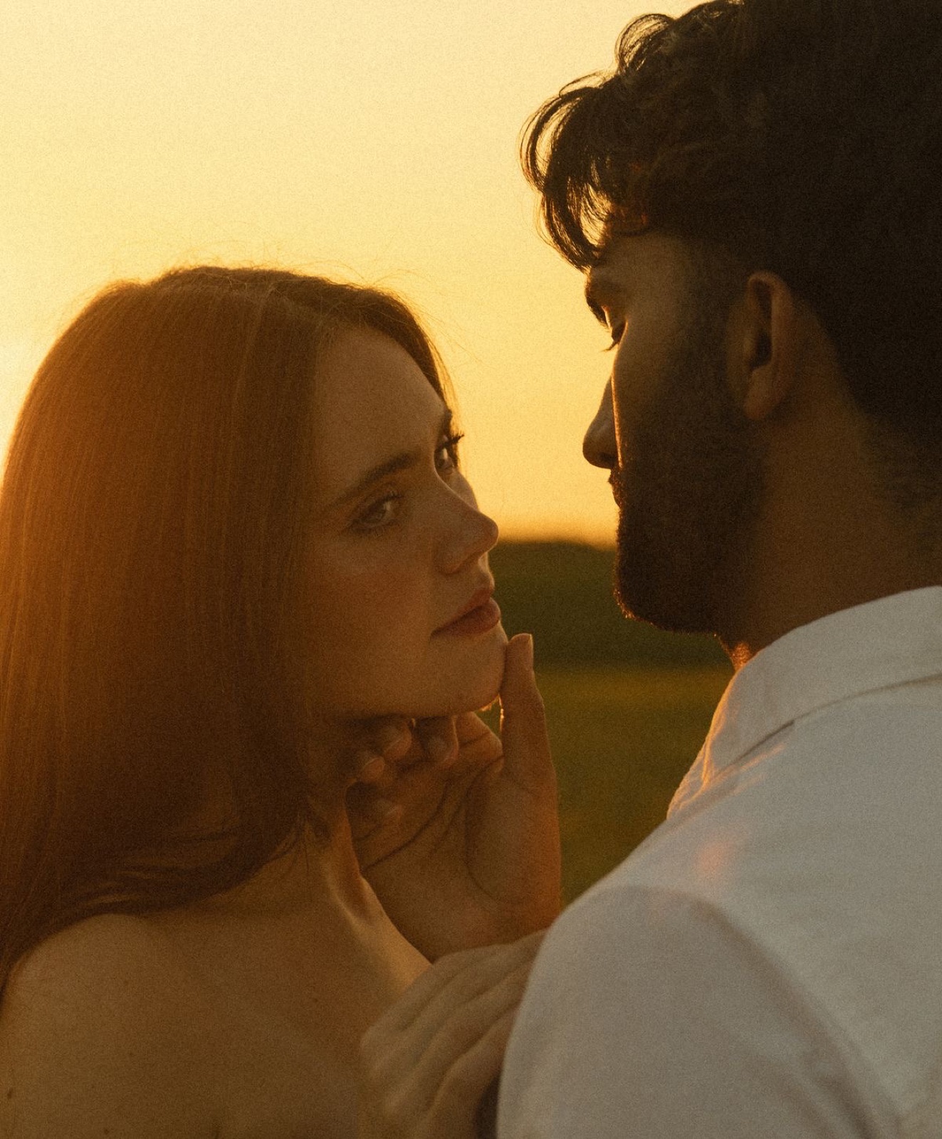 Couple facing each other at golden hour